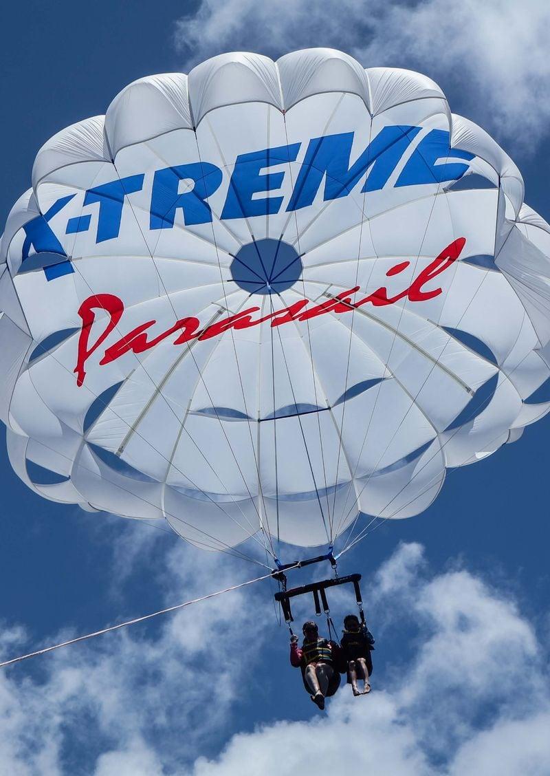 Guests soaring over Waikiki while parasailing